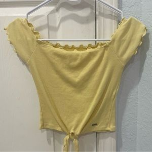 Yellow hollister low cut shirt with on or off the shoulder sleeves.
